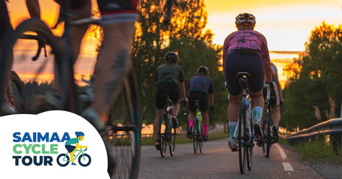Riders on the Saimaa Cycle Tour on a lakeside road at sunset in Finnish Lakeland