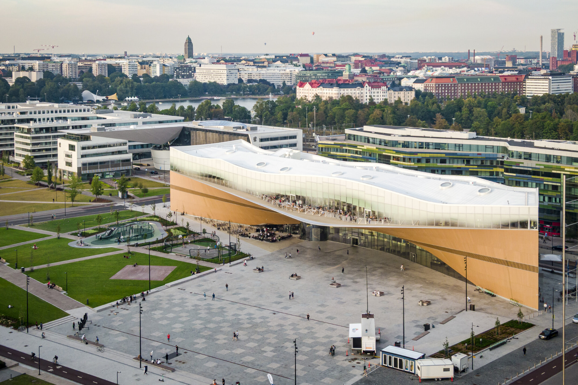 Aerial view of Oodi central library and Kansalaistori square across Helsinki's Töölönlahti