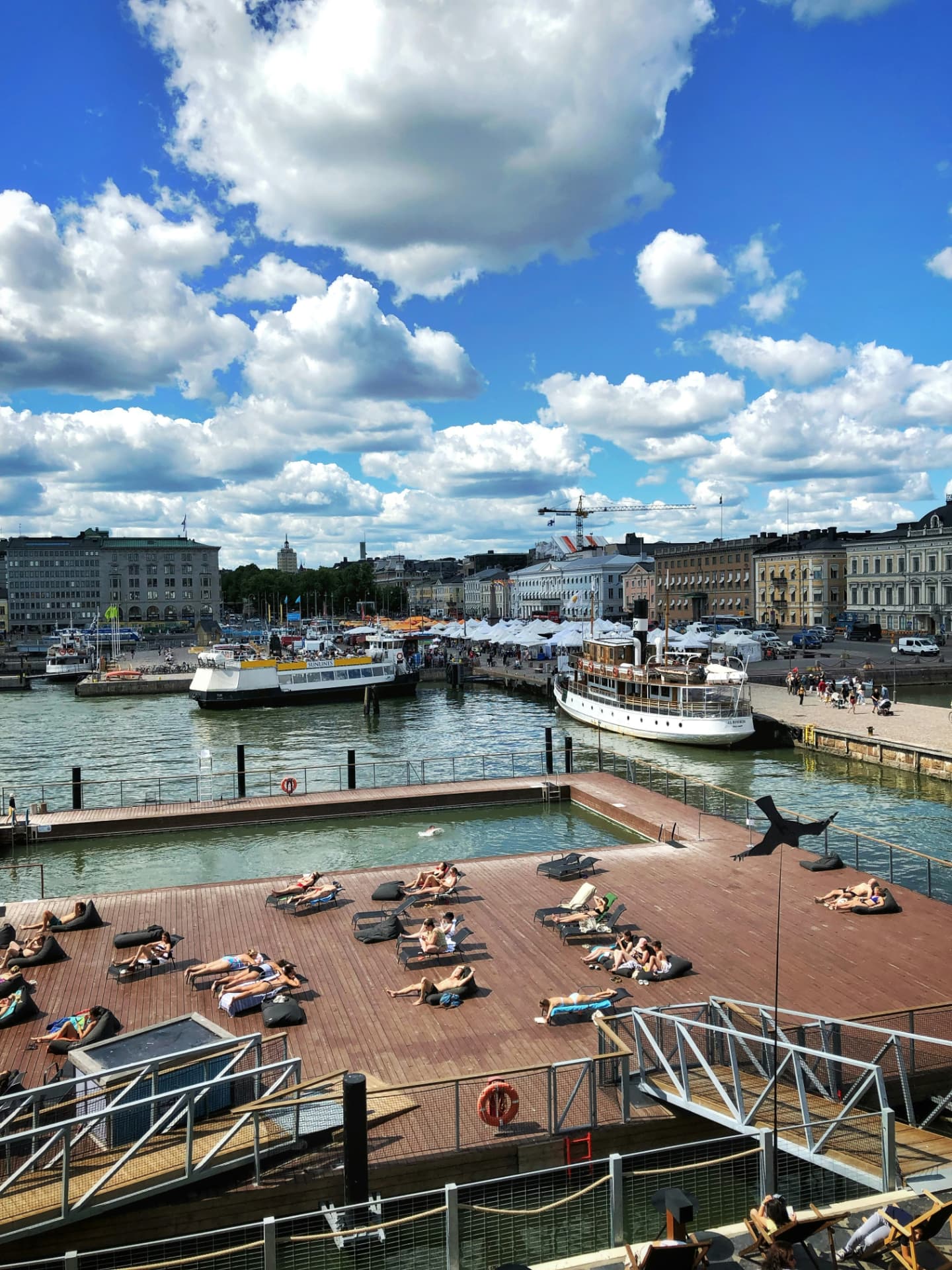 Helsinki Market Square, harbour steamers and the seawater pool deck on a bright summer day