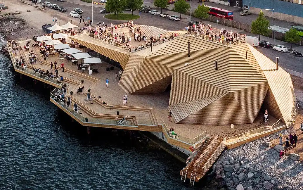 Aerial view of Löyly sauna's stepped timber terraces on the Baltic shore in Helsinki