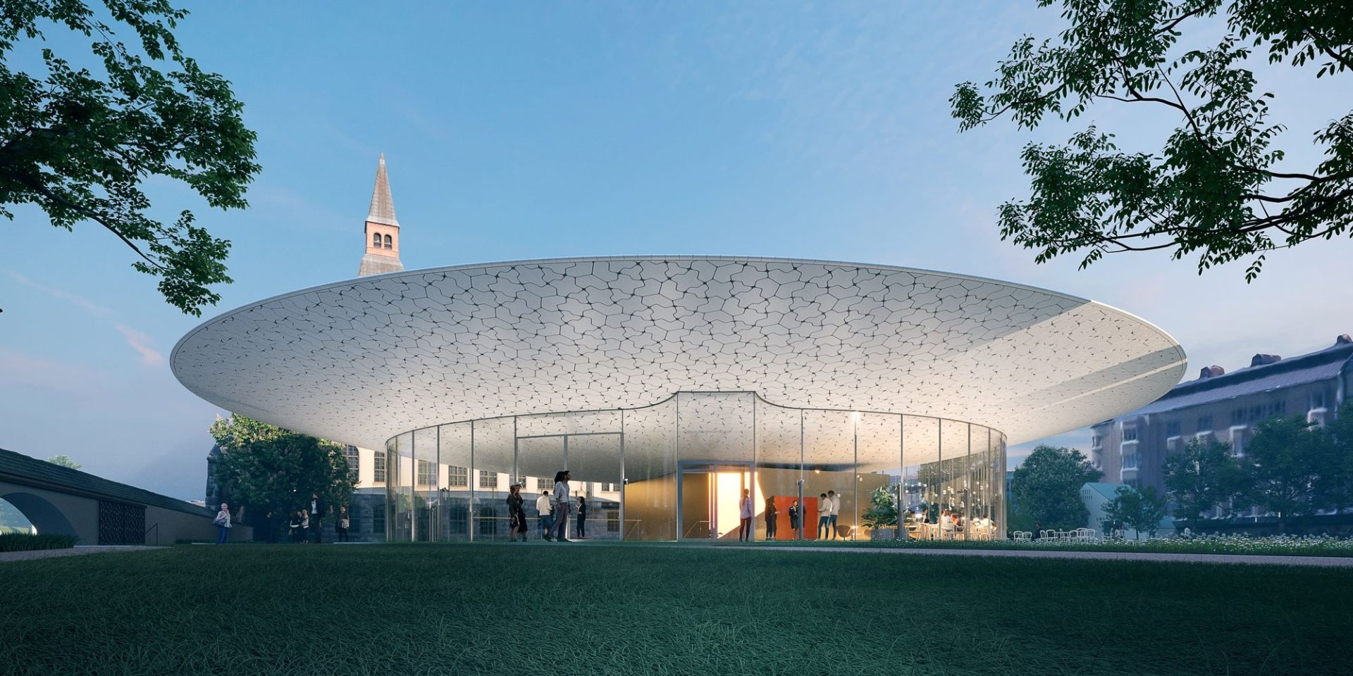 The glass and white-roofed new pavilion of the National Museum of Finland lit at dusk