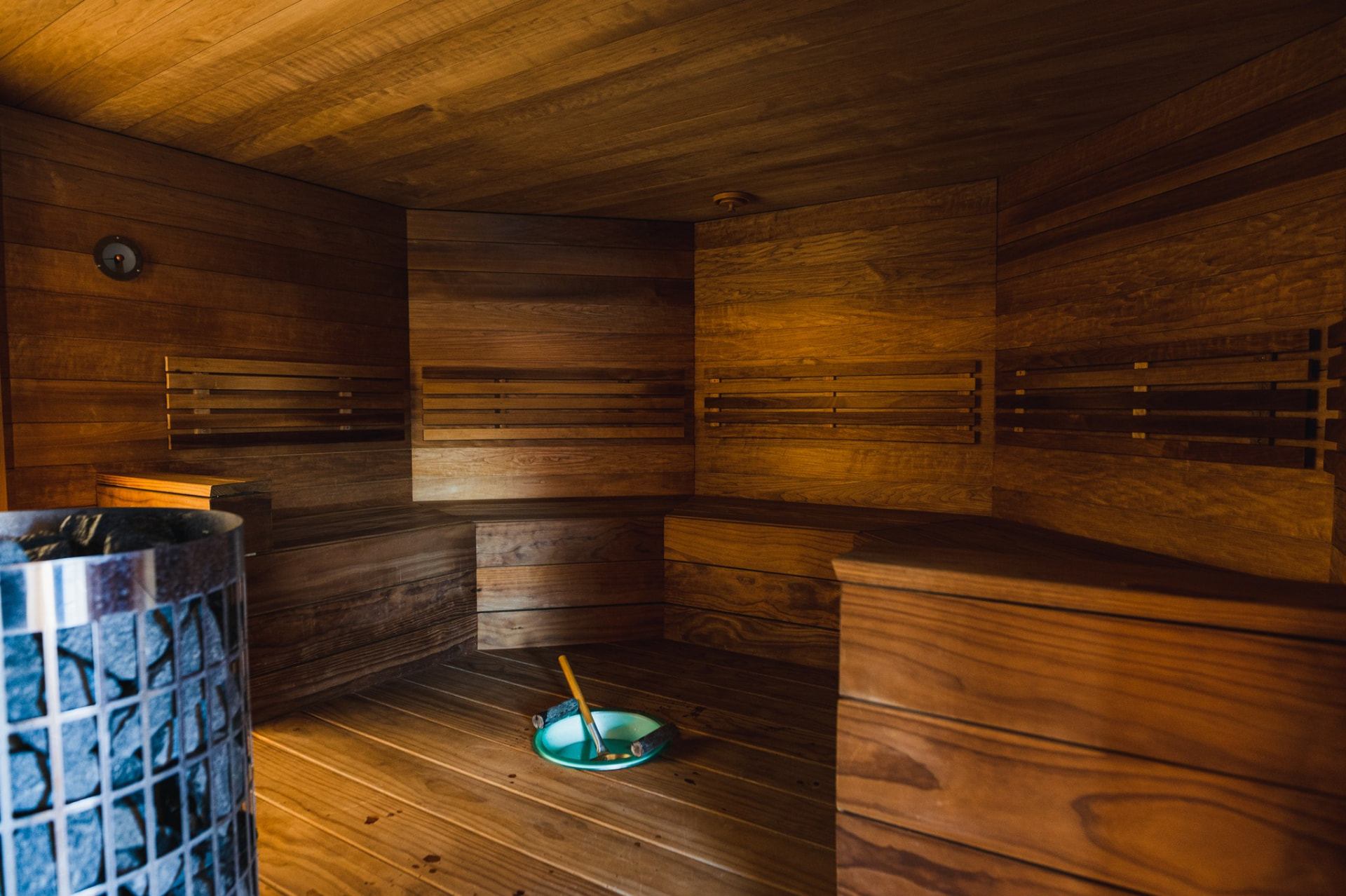 Warm timber interior of the Apukka sauna with stove and benches