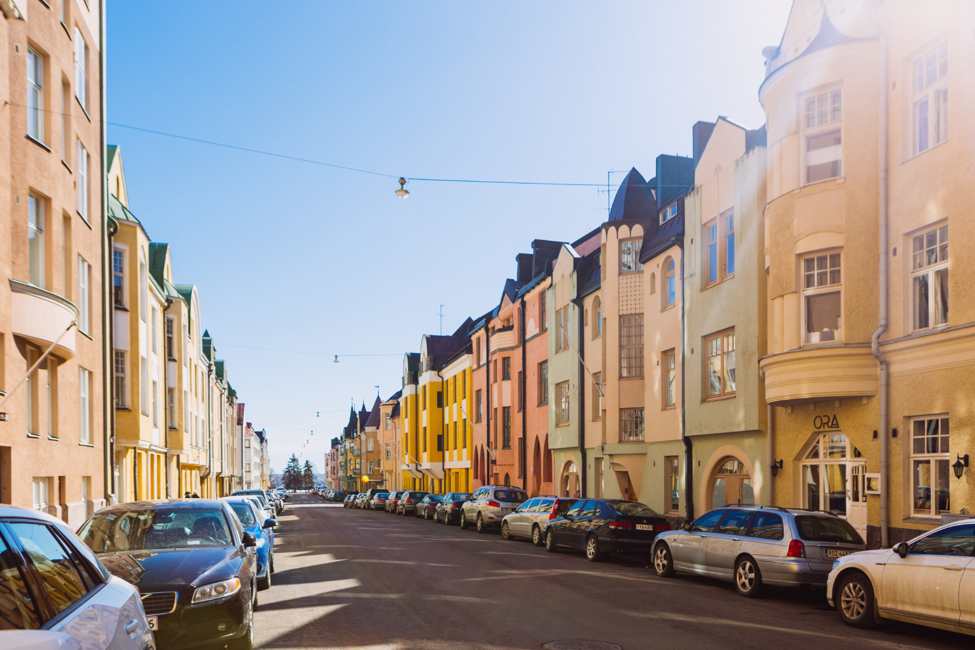 Pastel art nouveau facades lining Huvilakatu street in Helsinki on a clear day