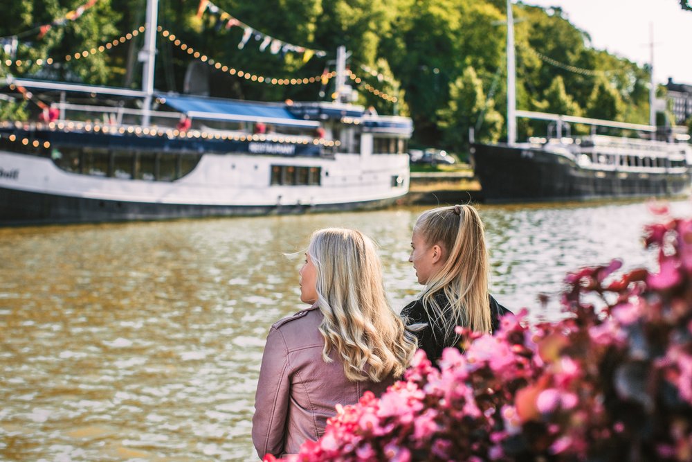 Historic restaurant ships moored along the Aura river in Turku in evening light